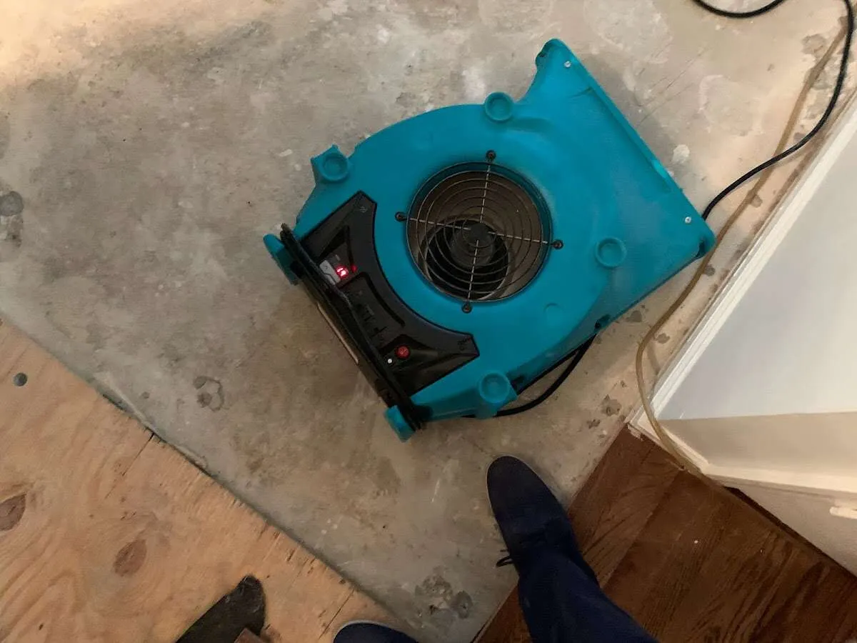 Air mover drying subfloor during Leak Detection & Repair in Arcata